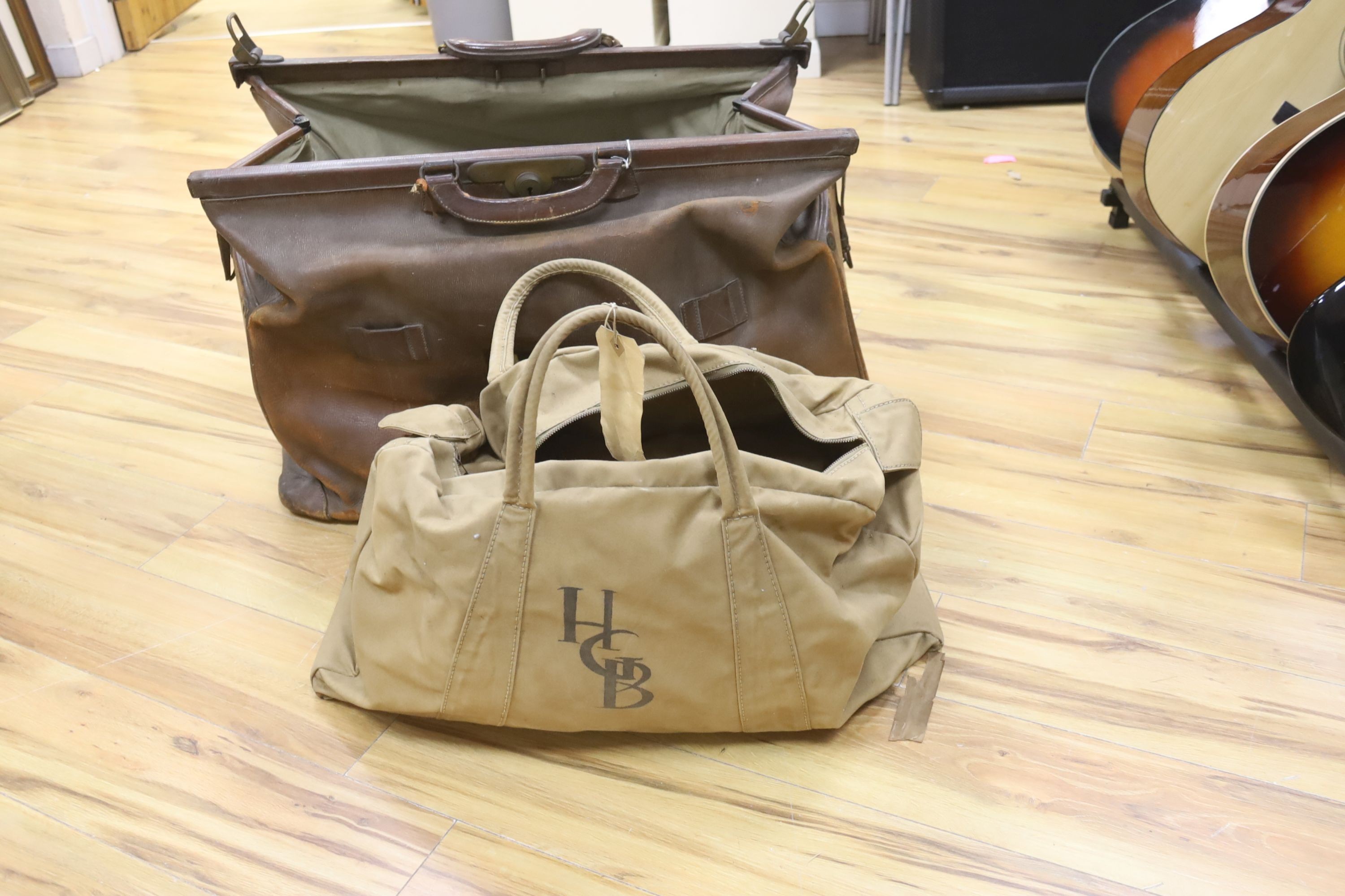 A large Gladstone bag, military canvas contents
